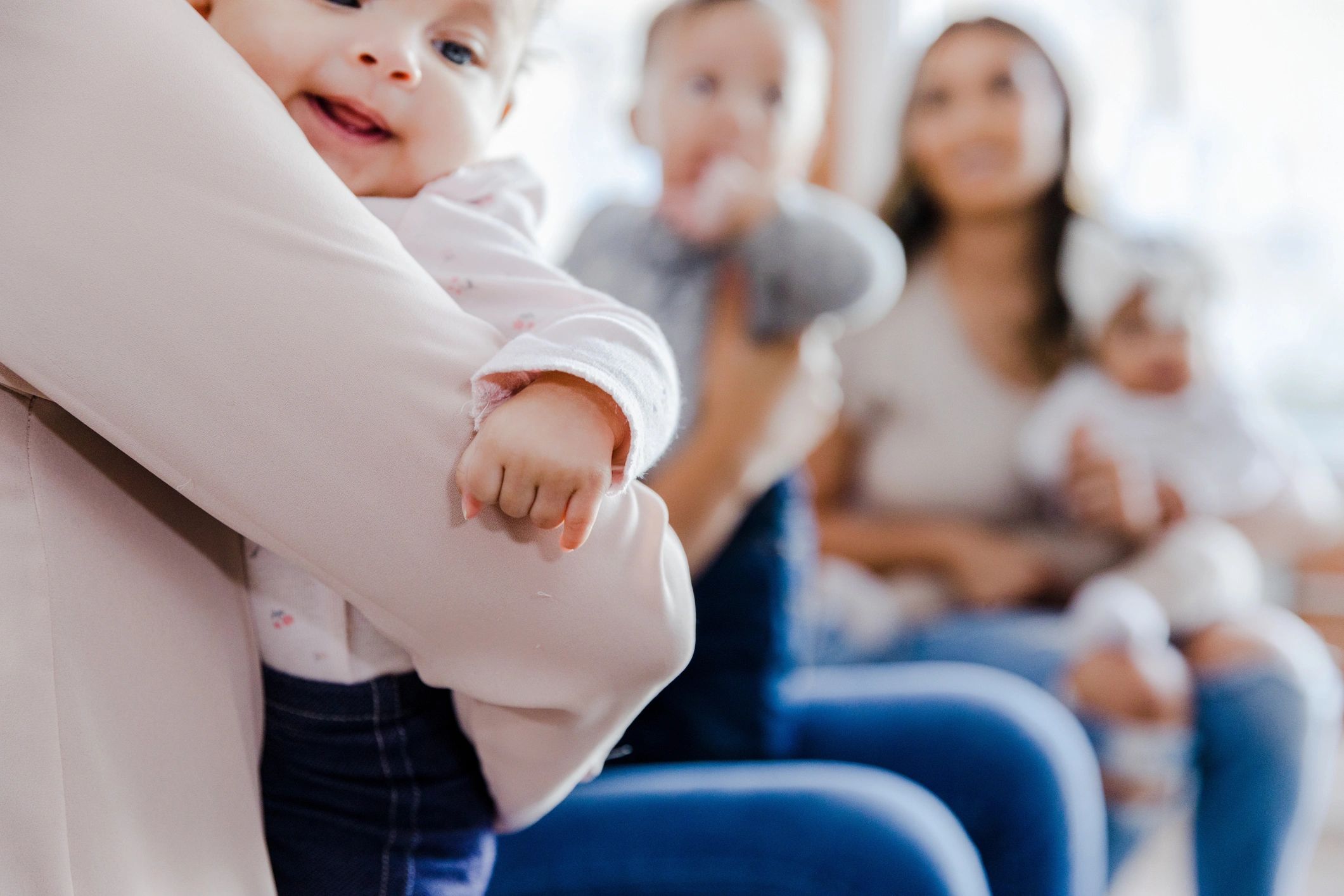 Caregiver holding an infant in a warm early learning setting