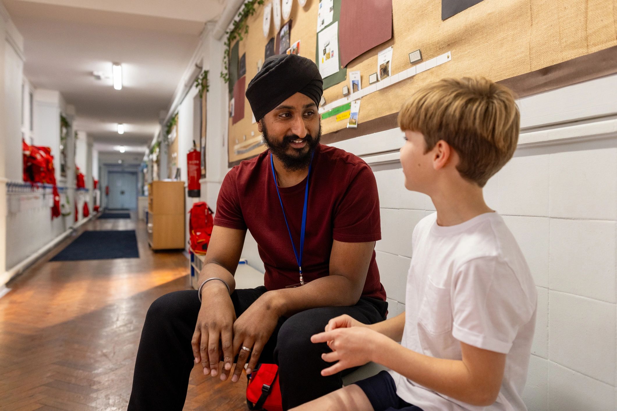Teacher supporting a young child with care and attention