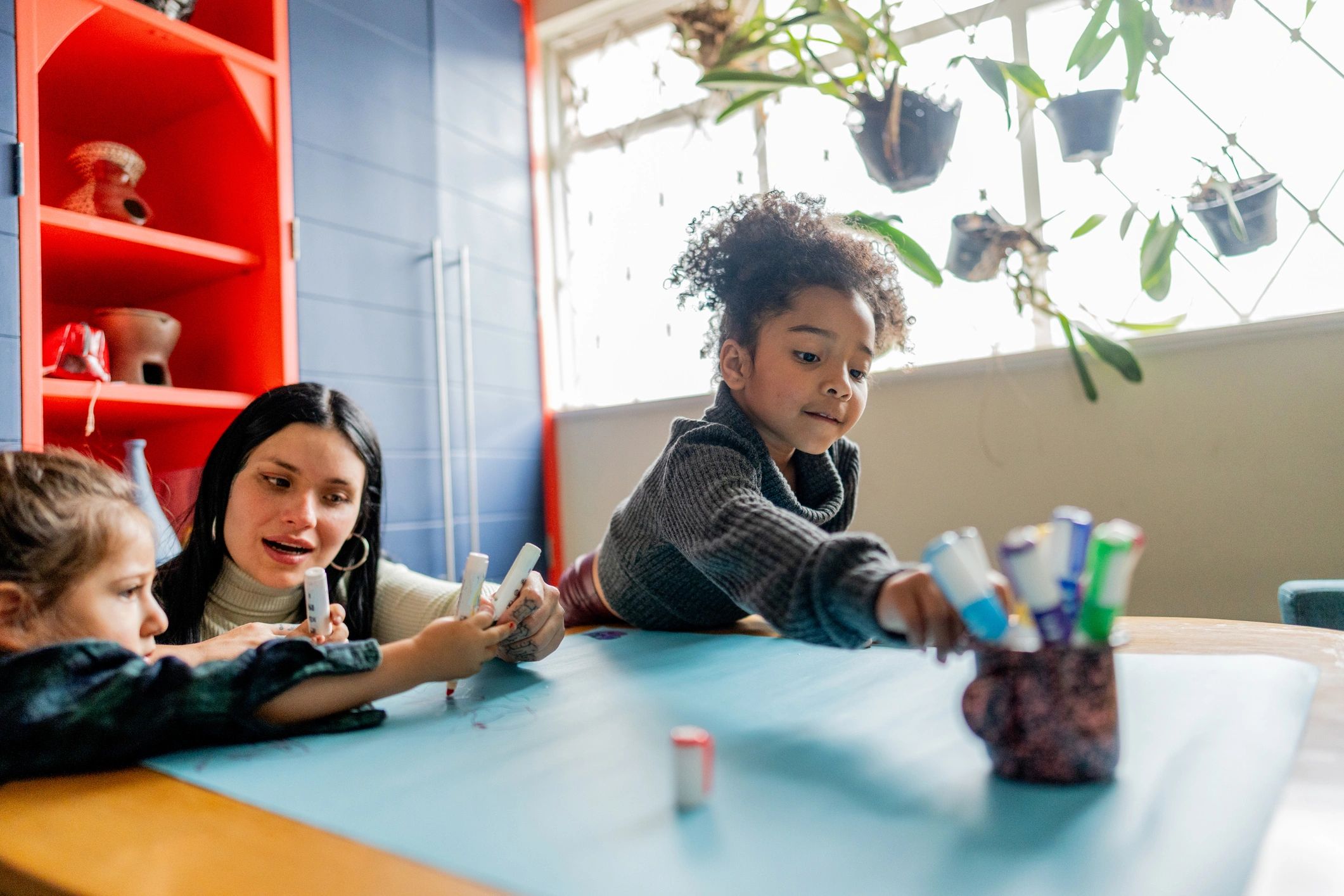Toddler learning activity with teacher support